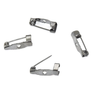 Macro view of four gunmetal safety pin brooch backs for DIY jewelry and garment making