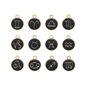 Macro view of twelve zodiac charms with black enamel and gold alloy for DIY jewelry