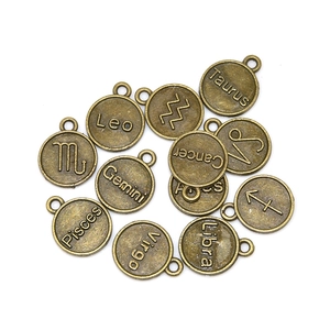 Macro detail of retro bronze alloy zodiac pendants with engraved constellation names
