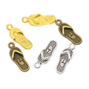 Detailed view of flip-flop alloy pendants in gold, bronze, and silver for DIY jewelry