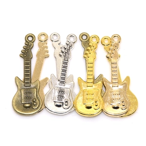 Detailed macro view of DIY vintage alloy guitar charms in four metallic electroplated colors
