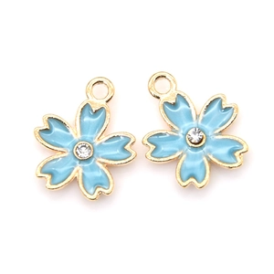 Detail of light blue cherry blossom charms with gold edges and central crystal accents