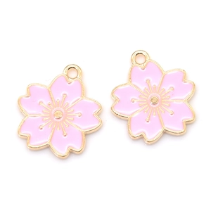 Detail view of two light pink enamel cherry blossom pendants with gold metal edges for DIY