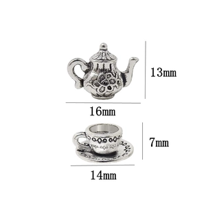 Vintage silver alloy miniature teapot and cup charms set with floral relief details