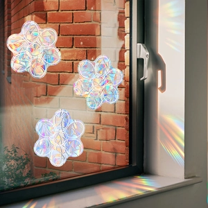 Rainbow laser prismatic window film showing hexagonal star patterns on glass with sunlight
