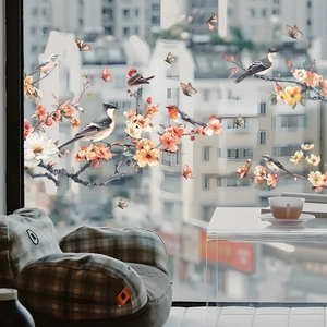 Detail of static glass window stickers featuring realistic birds, flowers, and butterflies