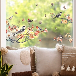 Detail of floral and bird static cling glass window film on bright French doors