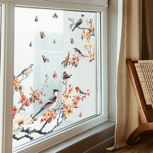 Detail of static window sticker with birds and pink flowers in a bright room