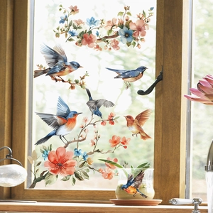 Detail of static window cling featuring watercolor birds and floral patterns on glass