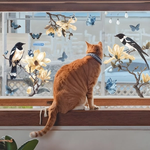 Stained glass hummingbird and magnolia flower window film stickers with a cat on a sill