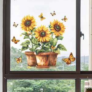 Detail of vibrant sunflower potted plant and butterfly window sticker on glass surface