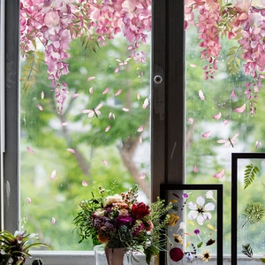 Macro detail of wisteria window film with falling petals and dragonfly static stickers