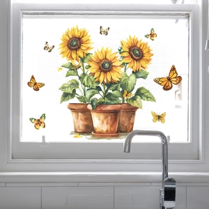 Sunflower and butterfly window decals in watercolor style on a kitchen glass window