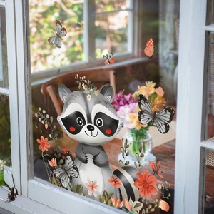 Detail of cute raccoon static window sticker with flowers on glass in a cozy room
