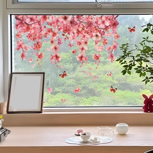 Detailed view of pink cherry blossoms and butterfly static window decals on glass
