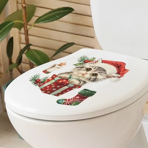 Detailed view of Christmas cat decal with Santa hat and gift box on white toilet lid