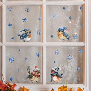Christmas window stickers featuring colorful birds in winter hats and blue snowflakes