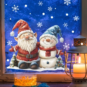 Christmas window stickers with Santa, snowman and snowflakes on a frosted blue glass