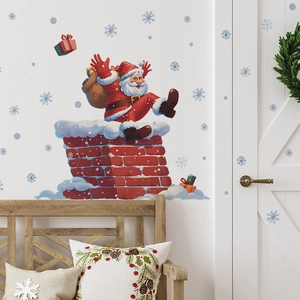 Sticker mural de Noël avec le Père Noël sortant d'une cheminée et des flocons bleus