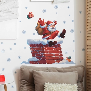 Détail de stickers muraux de Noël montrant le Père Noël sur une cheminée et flocons