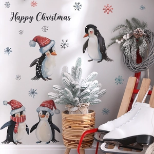 Christmas wall decals featuring four cute penguins and snowflakes for holiday home decor