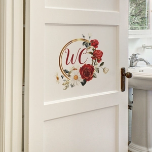 Detailed view of floral WC door sticker with red roses and daisies on a white door