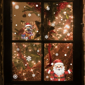 Detail of Christmas window stickers featuring cartoon Santa Claus, reindeer, and white snowflakes