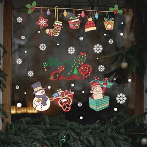 Christmas window stickers featuring Santa, snowman, and snowflakes on a glass door