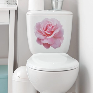 Detail of waterproof pink rose flower sticker applied on a white toilet tank