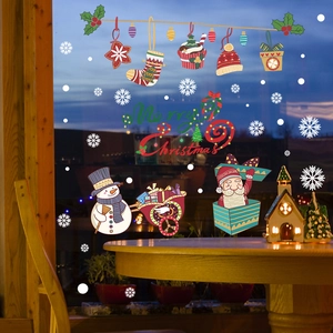 Close-up of Merry Christmas static window stickers with snowman and snowflake designs
