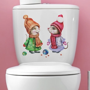 Close-up of cartoon mice stickers with winter scarves on a white toilet tank