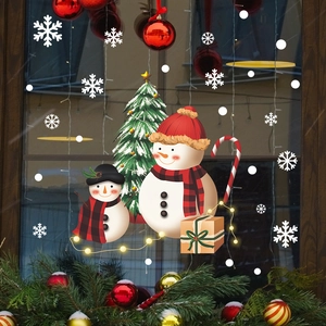 Christmas window stickers set with snowmen, festive tree and snowflakes on glass