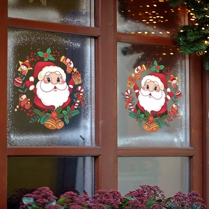 Christmas window stickers with cartoon Santa Claus and festive wreath on glass background