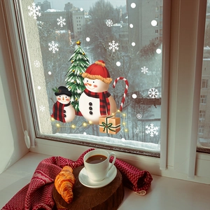 Detail view of festive Santa Claus and snowman window stickers on glass surface