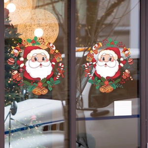 Christmas window stickers featuring Santa Claus wreaths with bells and holly on glass