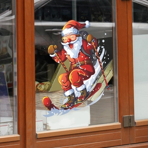 Close-up of a skiing Santa Claus static glass sticker on a wooden window frame