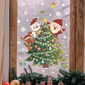Detail of Christmas tree window stickers with Santa and reindeer on a wooden window