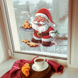 Christmas window stickers with Santa and gingerbread men displayed on a cozy snowy window