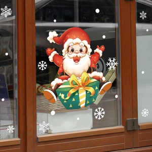 Detailed view of Santa Claus and green gift box stickers on a glass window background