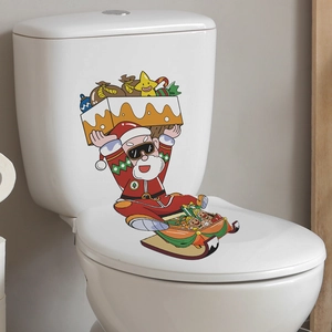 Detail of Christmas Santa and sleigh self-adhesive stickers on a white bathroom toilet