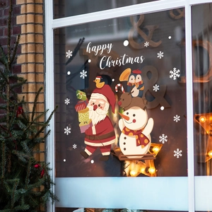 Christmas window stickers featuring Santa Claus, snowman, and reindeer on a glass surface