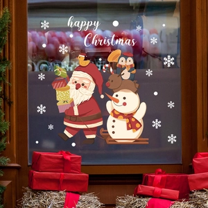 Detail of Christmas window stickers with Santa, reindeer and Happy Christmas text for holiday decor