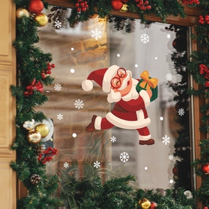 Christmas window decals featuring cartoon Santa Claus with gift box and white snowflakes