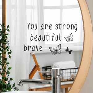 Detail of You are strong beautiful brave butterfly vinyl wall decals on a round mirror