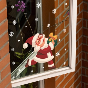 Detail of Santa Claus static window sticker with snowflakes on glass pane