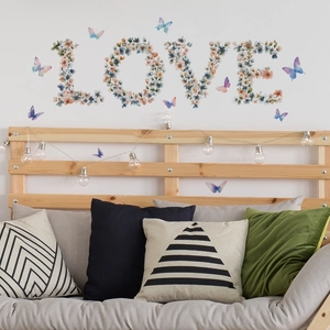 Close-up of floral LOVE letter wall stickers with 3D colorful butterflies in a cozy room