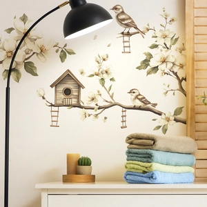 Pastel magnolia branches with birds and birdhouse wall decals in a cozy bedroom setting
