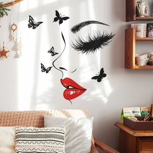 Chic wall decal featuring red lips and butterfly silhouettes in a bright modern living room
