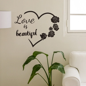 Detail of Love is beautiful wall sticker with heart and rose design in a cozy living room