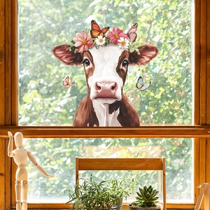 Window sticker with a brown cow wearing floral crown and butterflies in home setting